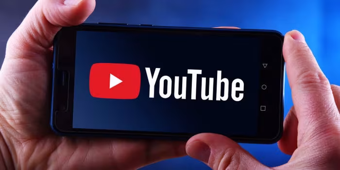 a person holding a phone with the youtube youtube logo on it